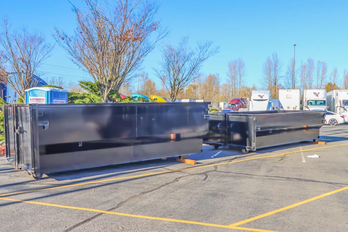 Professional dumpster rental service with roll-off container on residential driveway in Mount Sterling